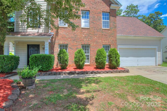 6310 Trevor Simpson Dr, Indian Trail, NC 28079 - view of front of house featuring concrete driveway, an attached garage, brick siding, and roof with shingles
