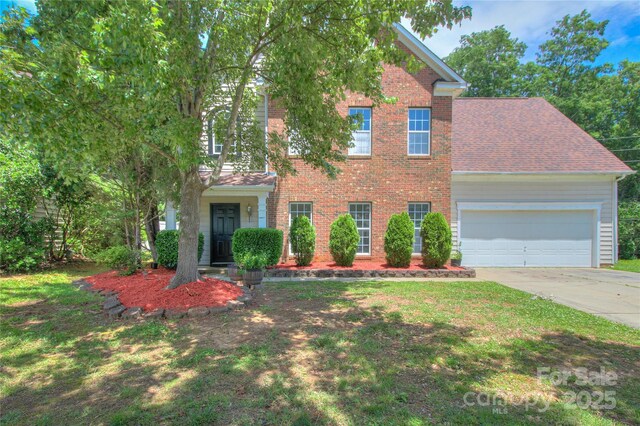 6310 Trevor Simpson Dr, Indian Trail, NC 28079 - view of front of house featuring brick siding, driveway, a garage, and a front lawn
