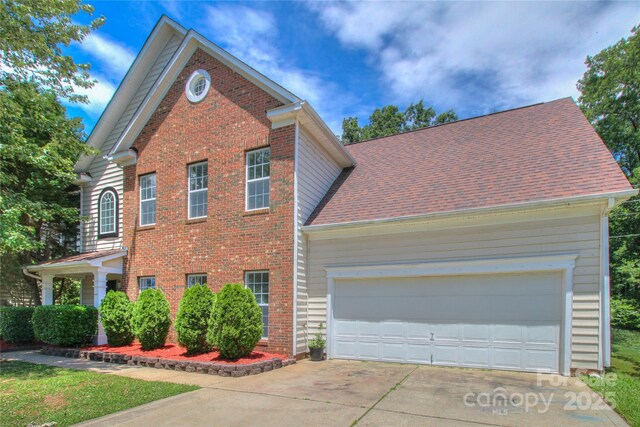 6310 Trevor Simpson Dr, Indian Trail, NC 28079 - traditional home with driveway, brick siding, and an attached garage
