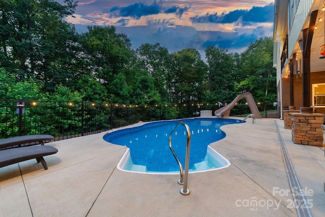 560 Blue Sky Dr, Dallas, NC 28034 - pool at dusk featuring a water slide and a patio area