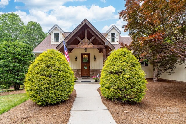 560 Blue Sky Dr, Dallas, NC 28034 - view of front facade with roof with shingles, board and batten siding, and stone siding
