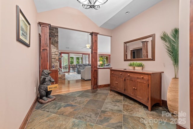 560 Blue Sky Dr, Dallas, NC 28034 - hall with ornate columns, vaulted ceiling, dark stone finish floors, and baseboards