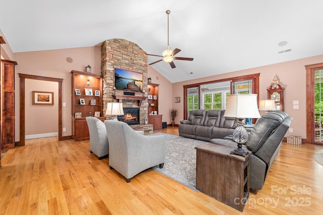 560 Blue Sky Dr, Dallas, NC 28034 - living room featuring a fireplace, ceiling fan, plenty of natural light, light wood-style flooring, and high vaulted ceiling