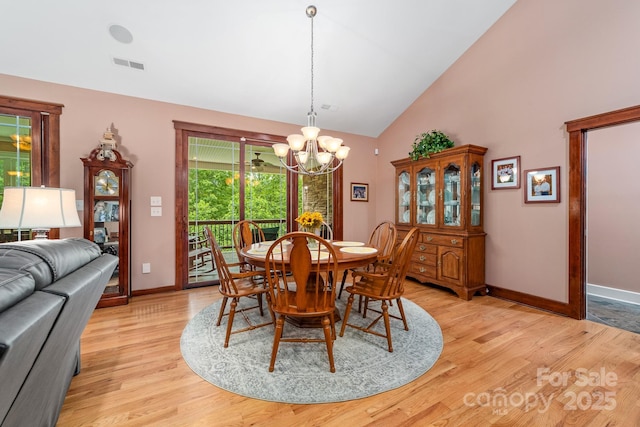 560 Blue Sky Dr, Dallas, NC 28034 - dining space with a chandelier, light wood-style flooring, baseboards, and high vaulted ceiling