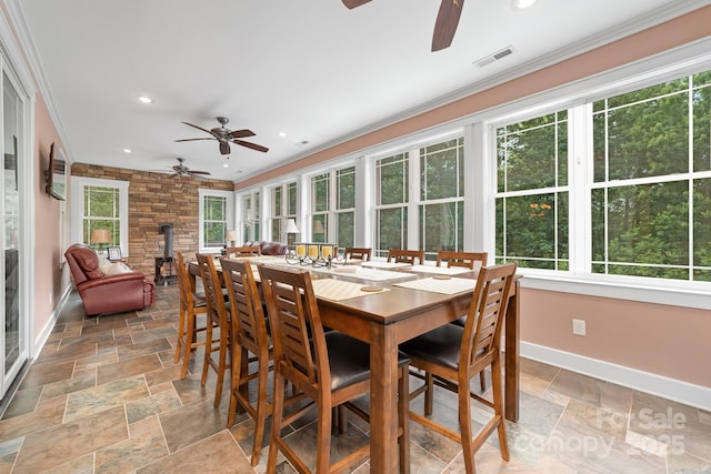 560 Blue Sky Dr, Dallas, NC 28034 - sunroom with baseboards, ornamental molding, stone tile flooring, recessed lighting, and a wood stove