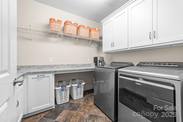 560 Blue Sky Dr, Dallas, NC 28034 - laundry room featuring washing machine and clothes dryer, cabinet space, and stone finish flooring
