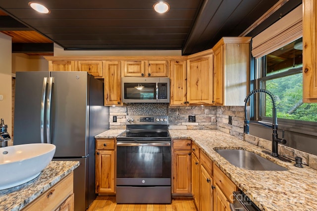 111 Grizzly Den Way, Marion, NC 28752 - kitchen with appliances with stainless steel finishes, a sink, wood ceiling with exposed beams, light wood-style floors, and backsplash