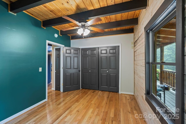 111 Grizzly Den Way, Marion, NC 28752 - unfurnished bedroom featuring baseboards, wood ceiling with exposed beams, light wood-style flooring, and a closet
