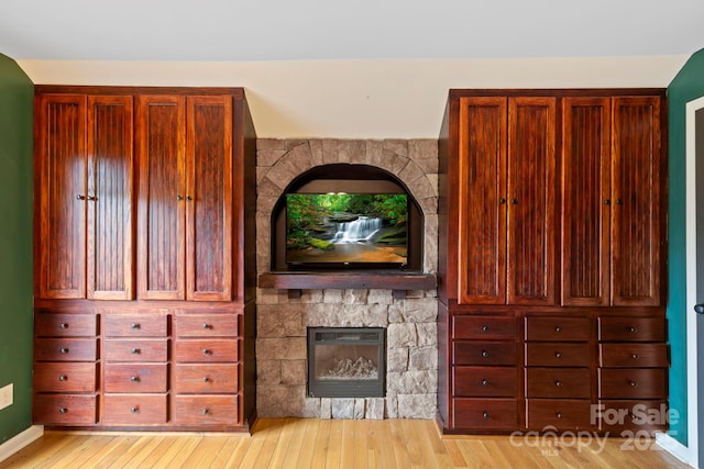 111 Grizzly Den Way, Marion, NC 28752 - unfurnished living room featuring light wood-type flooring and a stone fireplace