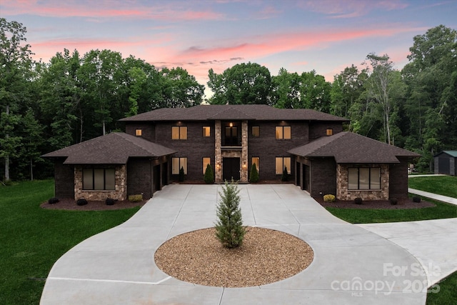 3020 Brooks Mill Ln, Wingate, NC 28174 - prairie-style house with curved driveway, a garage, and a front yard