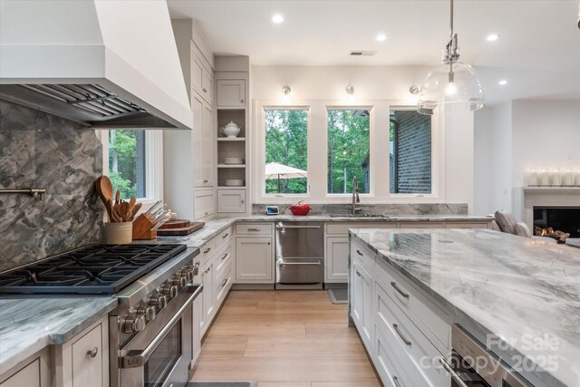 3020 Brooks Mill Ln, Wingate, NC 28174 - kitchen featuring custom range hood, appliances with stainless steel finishes, a sink, recessed lighting, and light stone counters