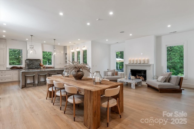 3020 Brooks Mill Ln, Wingate, NC 28174 - dining area with a lit fireplace, recessed lighting, plenty of natural light, and light wood finished floors