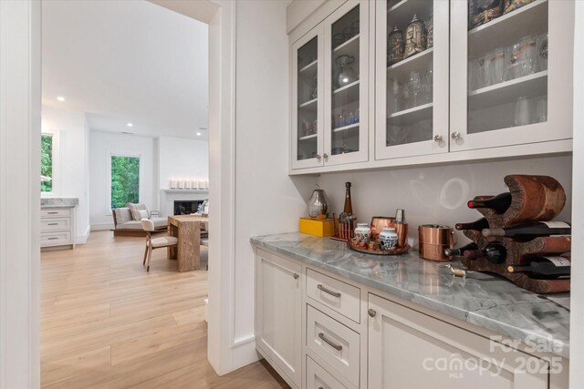 3020 Brooks Mill Ln, Wingate, NC 28174 - bar featuring a fireplace, light wood-type flooring, and recessed lighting