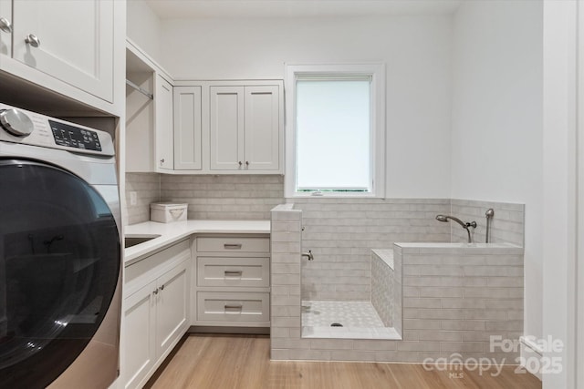 3020 Brooks Mill Ln, Wingate, NC 28174 - washroom with cabinet space and light wood-style floors