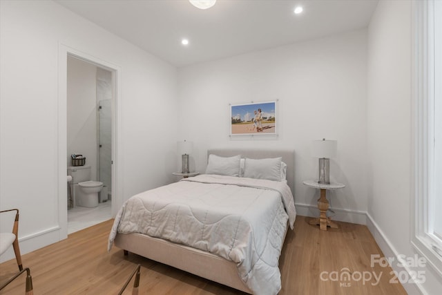 3020 Brooks Mill Ln, Wingate, NC 28174 - bedroom featuring light wood-style flooring, recessed lighting, ensuite bath, and baseboards