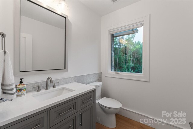 3020 Brooks Mill Ln, Wingate, NC 28174 - half bath featuring toilet, vanity, and wood finished floors