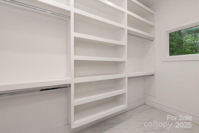 3020 Brooks Mill Ln, Wingate, NC 28174 - spacious closet featuring light marble finish flooring