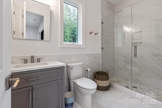 3020 Brooks Mill Ln, Wingate, NC 28174 - bathroom with vanity, a shower stall, toilet, and tile walls