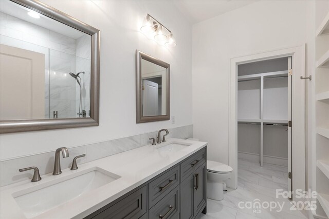 3020 Brooks Mill Ln, Wingate, NC 28174 - full bath featuring marble look tile flooring, toilet, double vanity, a shower, and a walk in closet