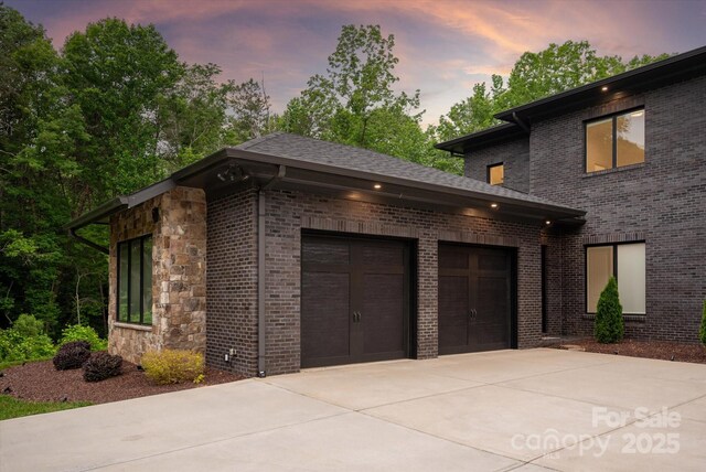 3020 Brooks Mill Ln, Wingate, NC 28174 - garage at dusk with driveway
