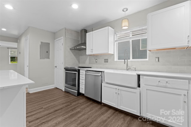 3400 Reid Ave, Charlotte, NC 28208 - kitchen featuring stainless steel appliances, wall chimney range hood, dark wood-type flooring, a sink, and backsplash