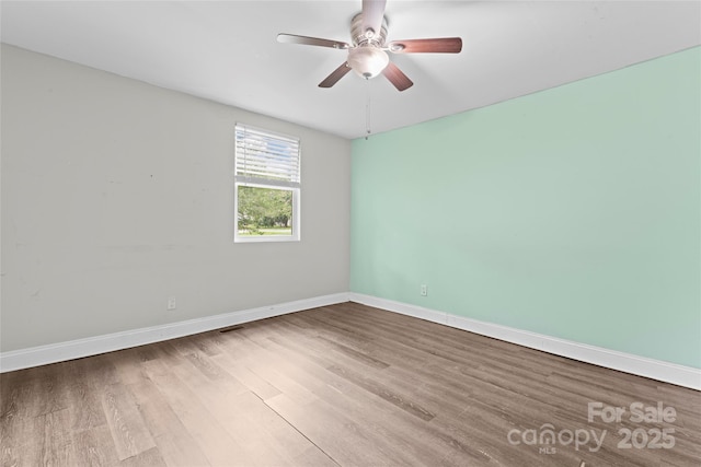 3400 Reid Ave, Charlotte, NC 28208 - spare room with wood finished floors, a ceiling fan, and baseboards
