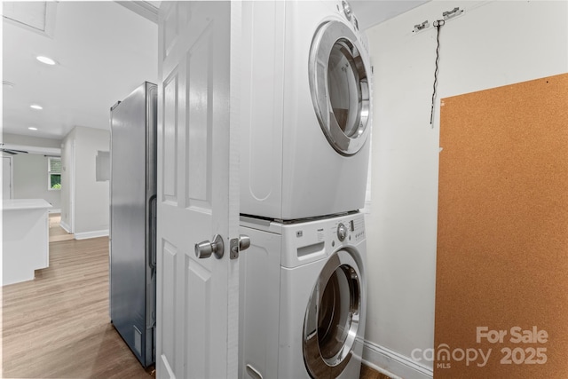 3400 Reid Ave, Charlotte, NC 28208 - laundry room with estacked washer and dryer, light wood-type flooring, recessed lighting, and baseboards