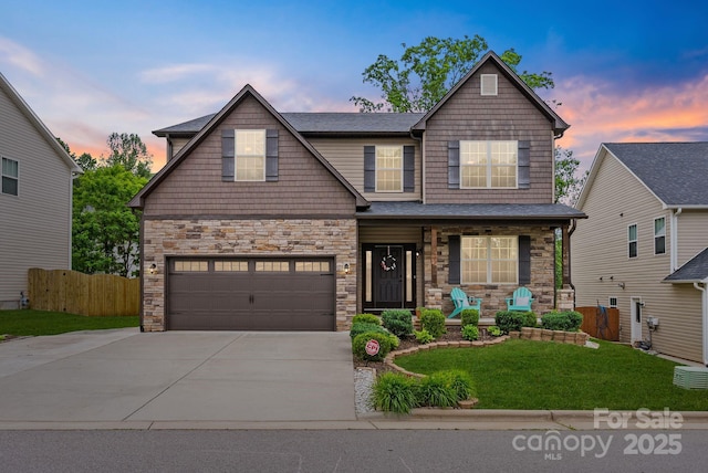 21 Henbit Way, Arden, NC 28704 - craftsman house featuring covered porch, driveway, stone siding, and an attached garage