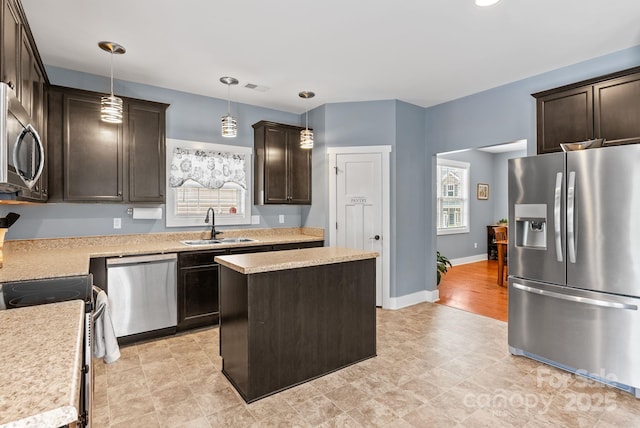 21 Henbit Way, Arden, NC 28704 - kitchen with stainless steel appliances, a sink, dark brown cabinets, light countertops, and recessed lighting