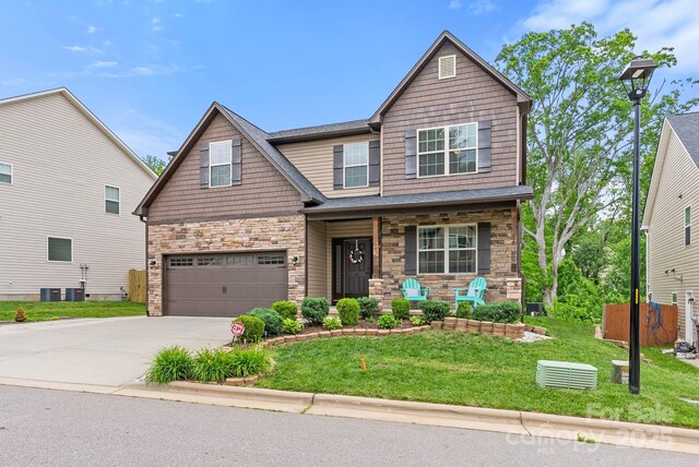 21 Henbit Way, Arden, NC 28704 - craftsman house featuring stone siding, a porch, concrete driveway, and a garage