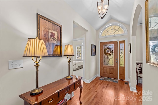 1070 Blueberry Rd, Salisbury, NC 28147 - foyer featuring lofted ceiling, light wood finished floors, a chandelier, and baseboards