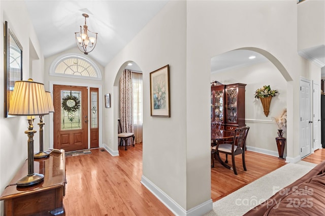 1070 Blueberry Rd, Salisbury, NC 28147 - foyer featuring arched walkways, light wood-style floors, a chandelier, baseboards, and lofted ceiling