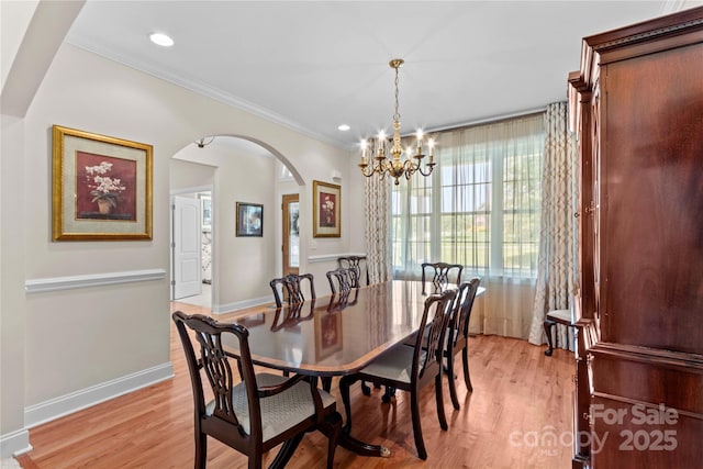 1070 Blueberry Rd, Salisbury, NC 28147 - dining area with arched walkways, a chandelier, light wood-type flooring, ornamental molding, and baseboards