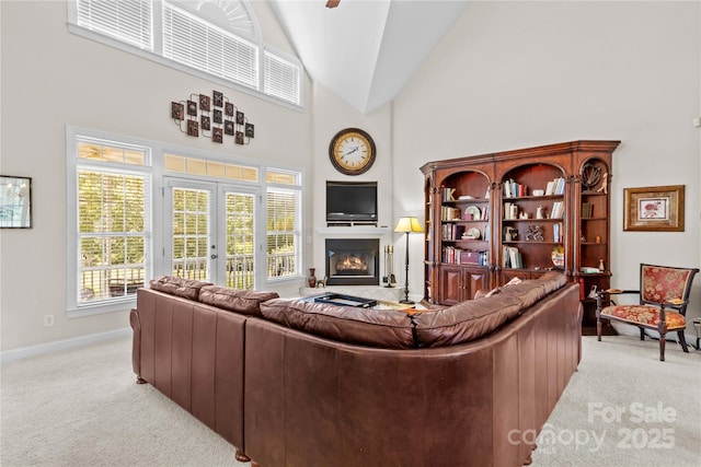 1070 Blueberry Rd, Salisbury, NC 28147 - living room with light colored carpet, baseboards, a glass covered fireplace, high vaulted ceiling, and a ceiling fan