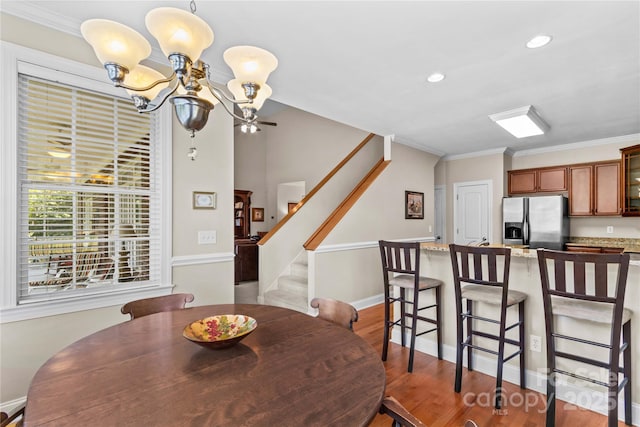 1070 Blueberry Rd, Salisbury, NC 28147 - dining space featuring stairway, a chandelier, wood finished floors, recessed lighting, and ornamental molding