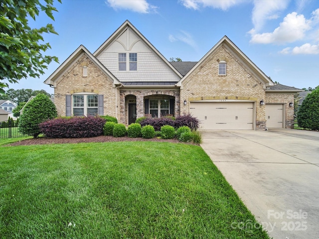 1004 Fairbanks Ct, Indian Trail, NC 28079 - view of front facade featuring a standing seam roof, concrete driveway, brick siding, a garage, and metal roof