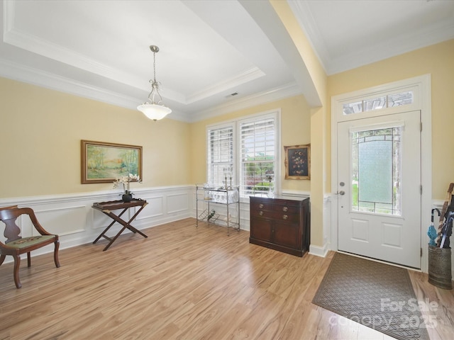 1004 Fairbanks Ct, Indian Trail, NC 28079 - entryway featuring ornamental molding, light wood-style floors, a tray ceiling, and a wainscoted wall