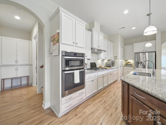 1004 Fairbanks Ct, Indian Trail, NC 28079 - kitchen featuring a sink, stainless steel appliances, under cabinet range hood, light wood-style floors, and recessed lighting