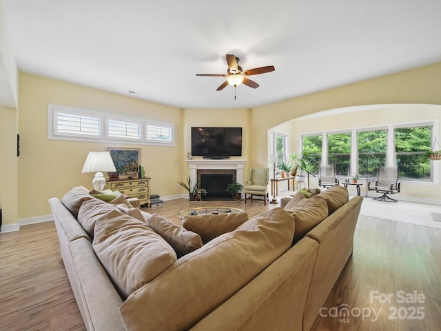 1004 Fairbanks Ct, Indian Trail, NC 28079 - living area featuring baseboards, a ceiling fan, wood finished floors, and a fireplace with flush hearth