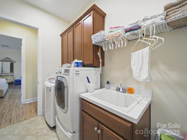 1004 Fairbanks Ct, Indian Trail, NC 28079 - washroom with washer and dryer, cabinet space, and baseboards