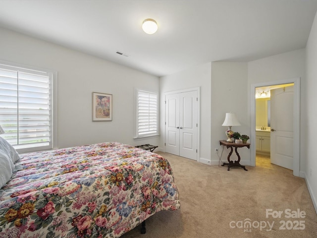 1004 Fairbanks Ct, Indian Trail, NC 28079 - bedroom with light colored carpet, multiple windows, baseboards, and a closet