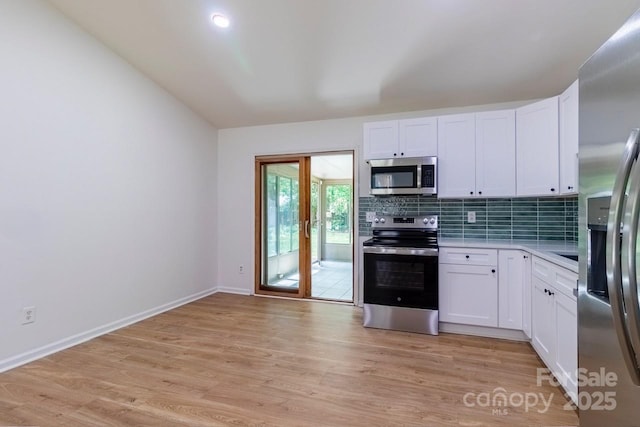 5233 Great Wagon Rd, Charlotte, NC 28215 - kitchen with appliances with stainless steel finishes, light wood-style floors, light countertops, and white cabinetry