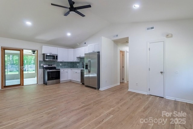 5233 Great Wagon Rd, Charlotte, NC 28215 - kitchen featuring stainless steel appliances, ceiling fan, lofted ceiling, white cabinets, and light wood-style flooring