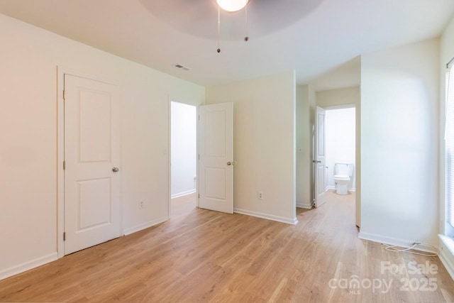 5233 Great Wagon Rd, Charlotte, NC 28215 - unfurnished bedroom featuring light wood-type flooring, ensuite bathroom, and baseboards