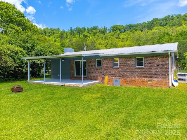 285 Painter Rd S, Cullowhee, NC 28723 - back of house with an outdoor fire pit, a patio area, a lawn, brick siding, and metal roof