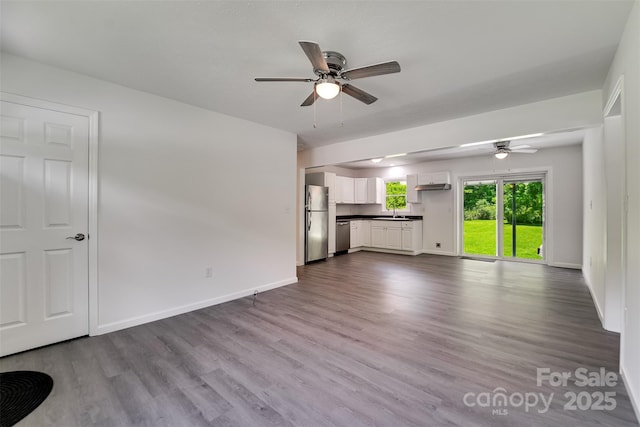 285 Painter Rd S, Cullowhee, NC 28723 - unfurnished living room with ceiling fan, a sink, dark wood finished floors, and baseboards