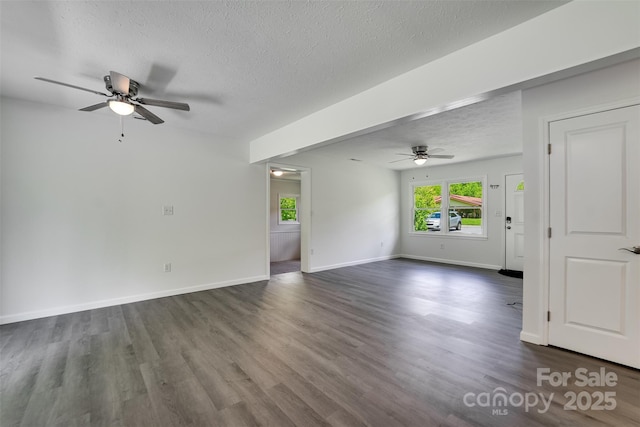 285 Painter Rd S, Cullowhee, NC 28723 - unfurnished living room featuring ceiling fan, healthy amount of natural light, a textured ceiling, and dark wood-type flooring
