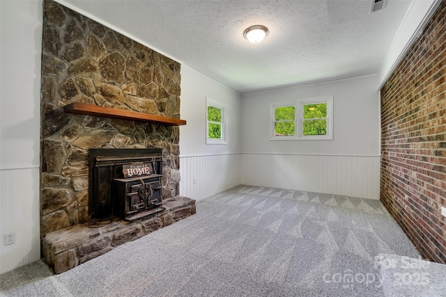 285 Painter Rd S, Cullowhee, NC 28723 - unfurnished living room with wainscoting, a textured ceiling, carpet floors, a fireplace, and ornamental molding