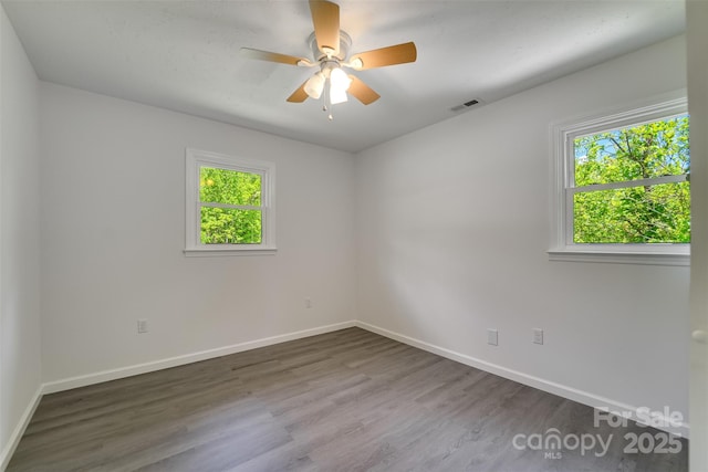 285 Painter Rd S, Cullowhee, NC 28723 - empty room with healthy amount of natural light, wood finished floors, and baseboards