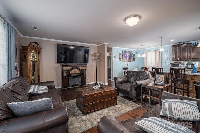 792 Carolina Mill Cir, Lincolnton, NC 28092 - living area featuring crown molding, a glass covered fireplace, wood finished floors, a chandelier, and baseboards